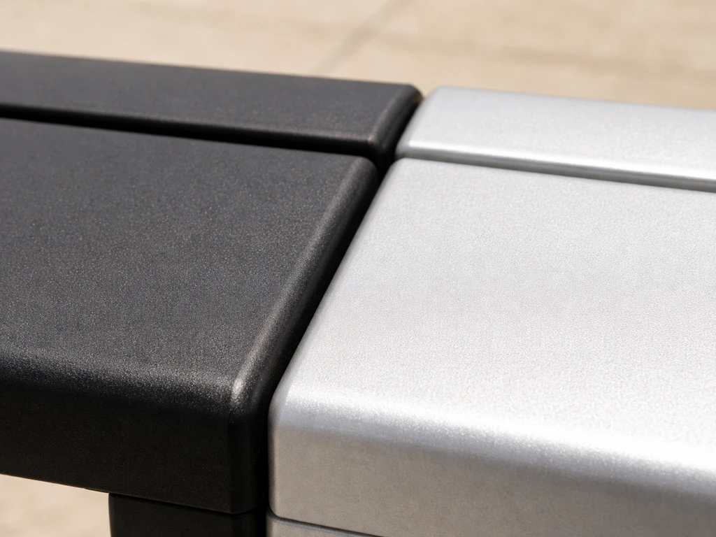 Close-up of dark matte black and light silver aluminum patio furniture finishes in bright sunlight