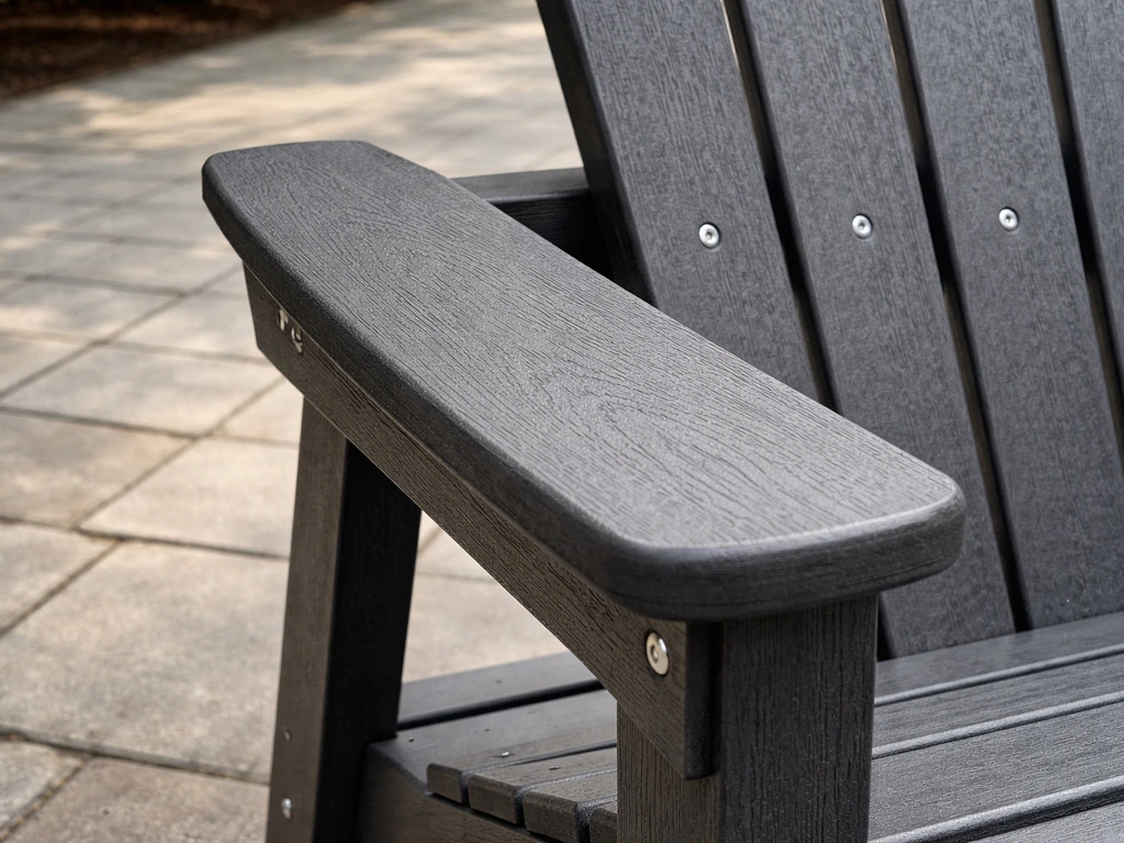 Close-up of HDPE recycled plastic patio furniture with molded wood-like texture on a quiet outdoor patio